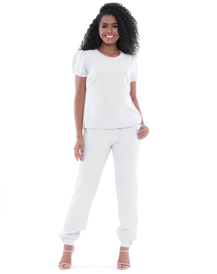 Scrub Feminino Antonella Branco em vista frontal de corpo inteiro, blusa solta e calça jogger de punho ajustado