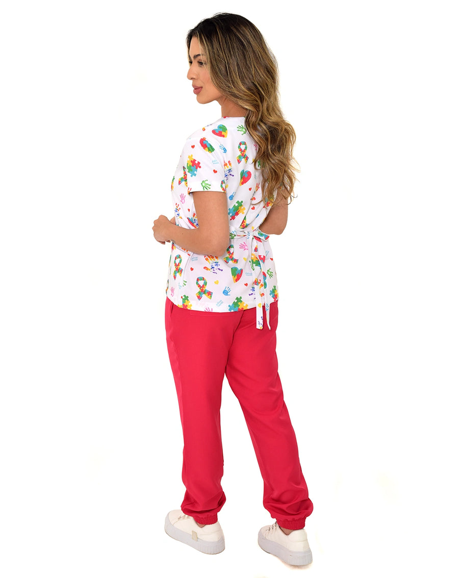 Scrub feminino estampado Autismo em Cores de costas, blusa com amarração na cintura e calça jogger vermelha