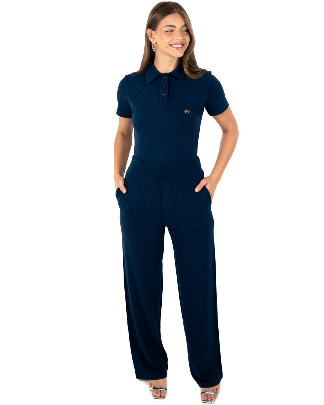 Scrub feminino Ivy moletinho azul marinho de frente, mãos nos bolsos da calça pantalona e blusa gola polo — foto 3