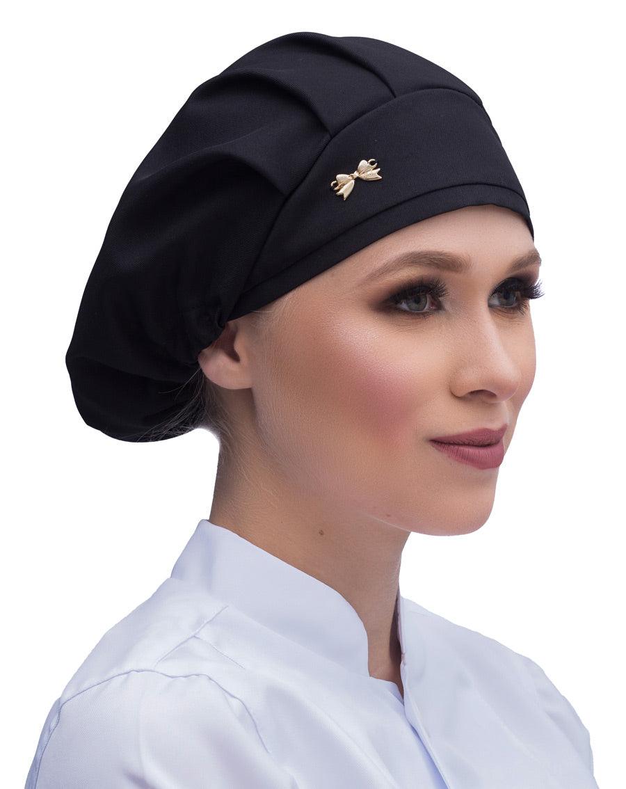 Touca elástico feminina preta em modelo, vista lateral, tecido liso com pregas e lacinho dourado na frente